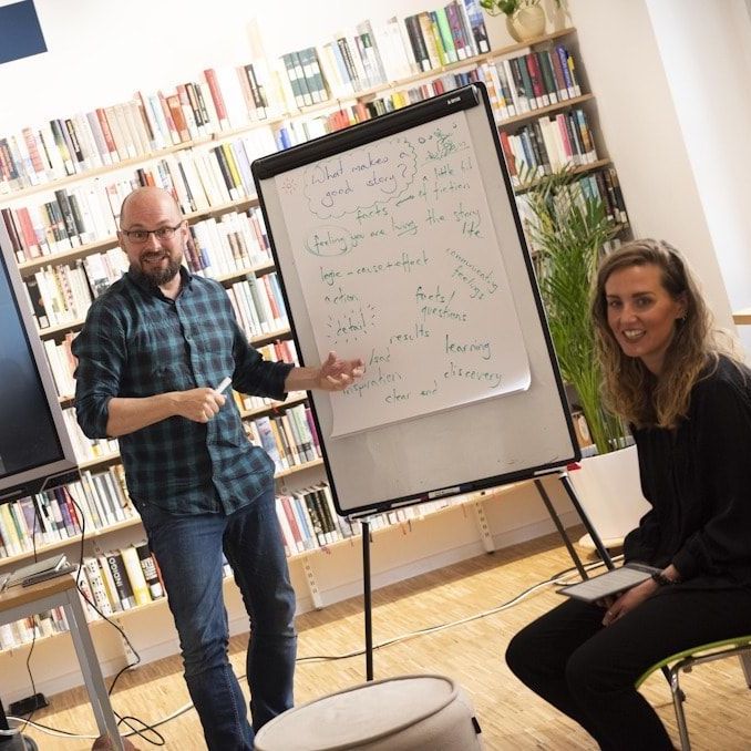 Hannah and Will by a white board